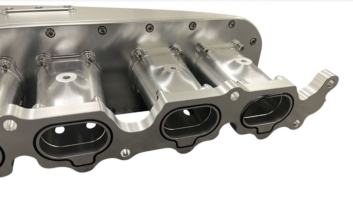 Jack Spania Racing billet 2JZ GTE intake manifold with throttle body and six injectors for high-performance engine tuning.