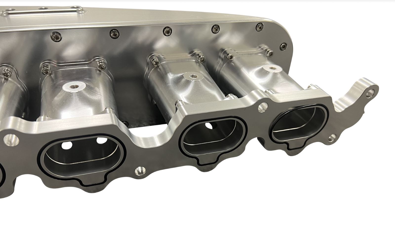 Jack Spania Racing billet 2JZ GTE intake manifold with throttle body and six injectors for high-performance engine tuning.