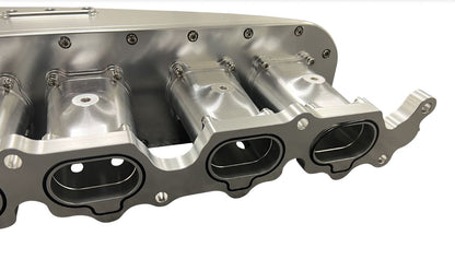 Jack Spania Racing billet 2JZ GTE intake manifold with throttle body and six injectors for high-performance engine tuning.