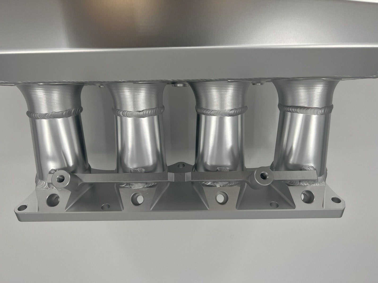 90mm Ultra Side Feed Intake Manifold for K Series K20 K24 engines by Jack Spania Racing, showing the black metal engine part.