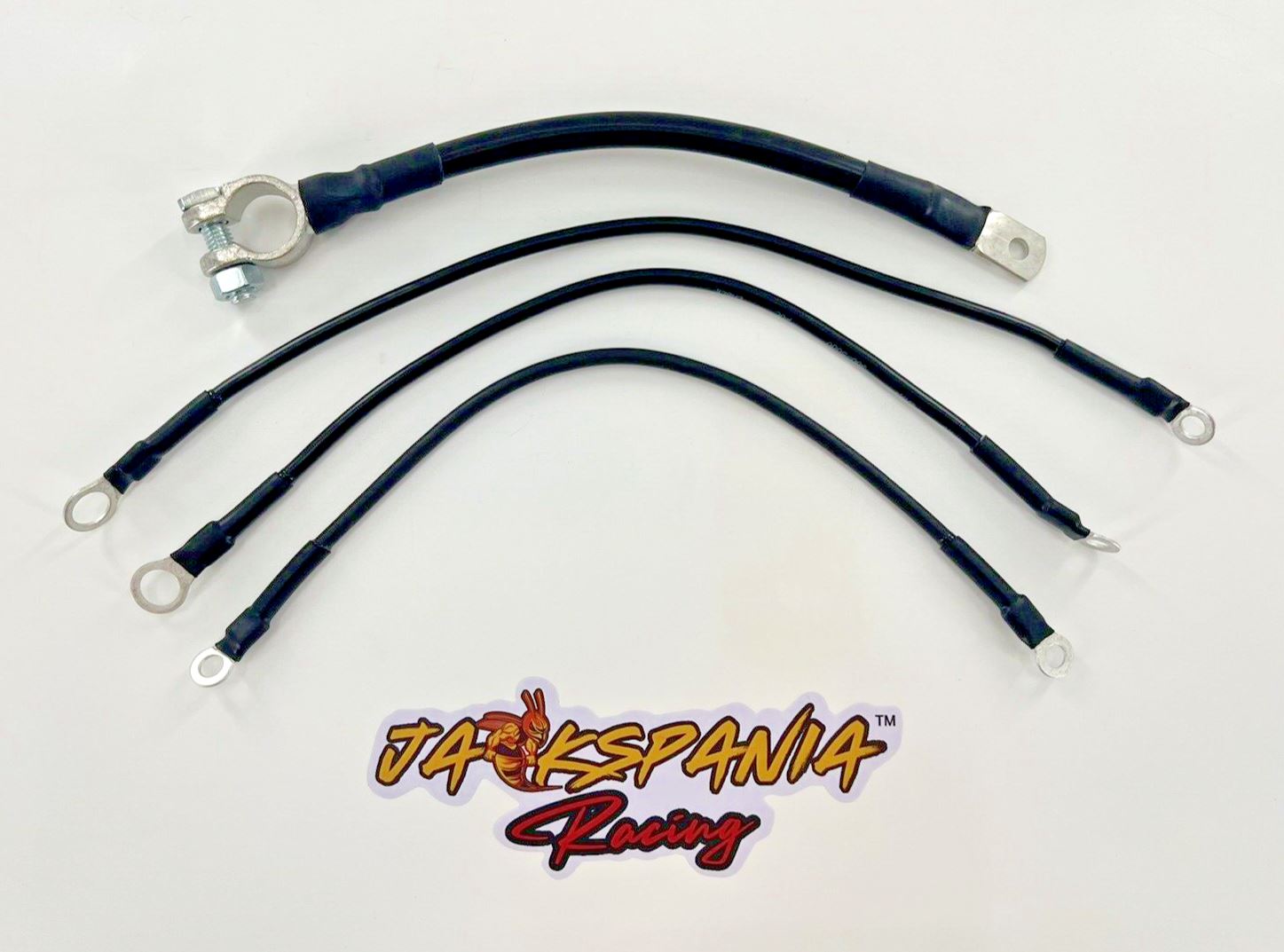 Heavy duty battery ground strap kit for Honda Acura B D H K series engines, by Jack Spania Racing, with transmission parts in image.