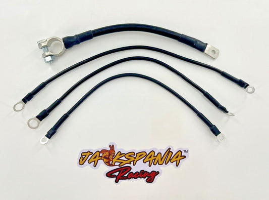 Heavy duty battery ground strap kit for Honda Acura B D H K series engines, by Jack Spania Racing, with transmission parts in image.