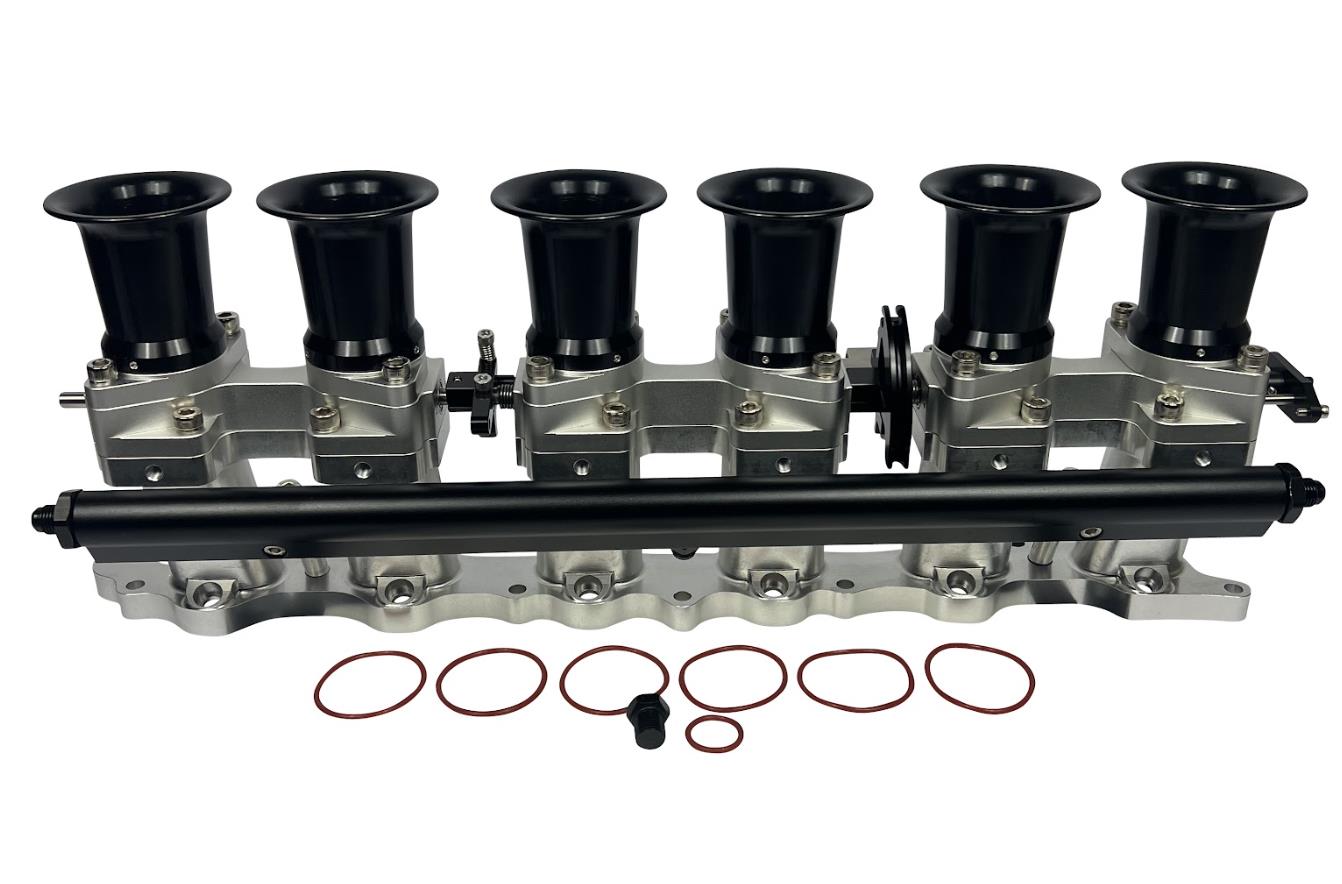 JackSpania Racing intake manifold with individual throttle bodies, fuel rail, and engine parts for 2JZGE engine.