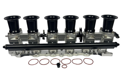 JackSpania Racing intake manifold with individual throttle bodies, fuel rail, and engine parts for 2JZGE engine.