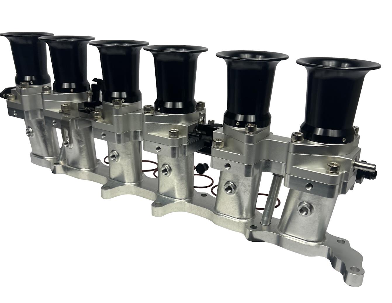 JackSpania Racing 2JZGE intake manifold with individual throttle bodies, fuel rail, and engine components for performance upgrade.