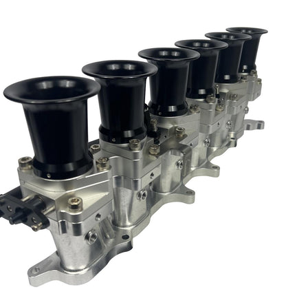 JackSpania Racing 2JZGE intake manifold with individual throttle bodies and fuel rail for engine performance.