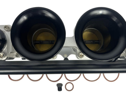 JackSpania Racing 2JZGE intake manifold with individual throttle bodies, fuel rail, and engine parts for enhanced performance.