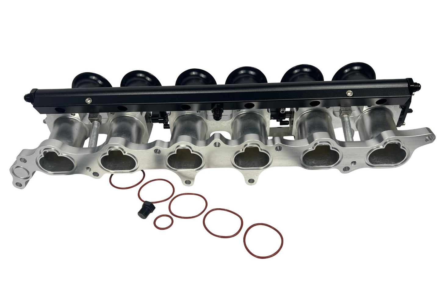 JackSpania Racing 2JZGE intake manifold with individual throttle bodies, fuel rail, and engine parts for performance engines.
