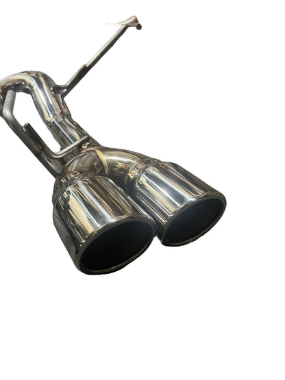 Stainless steel axle back delete exhaust muffler for Subaru WRX by JackSpania Racing, showing the polished metal and exhaust outlet.