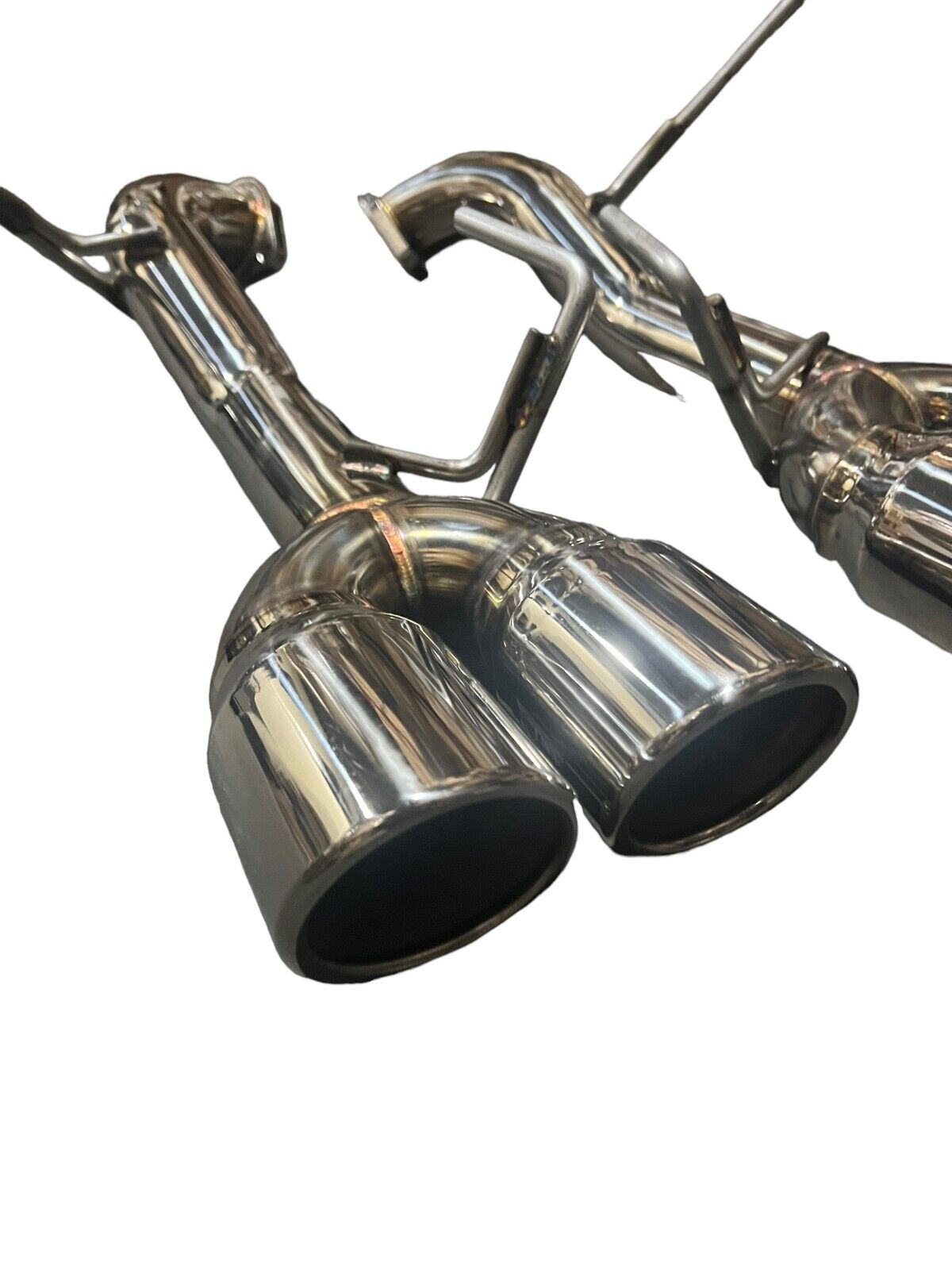 Stainless steel axle back delete exhaust muffler for Subaru WRX by JackSpania Racing, showing polished metal finish and mounting details.