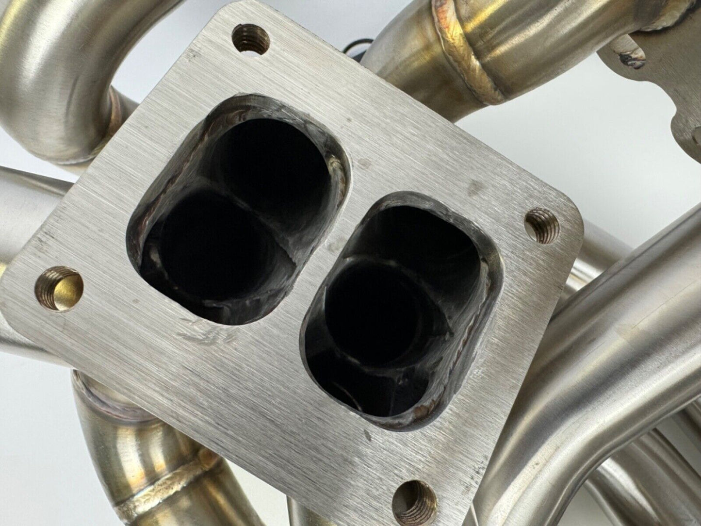 JackSpania Racing RB20 RB25 RB26 T4 top mount turbo manifold for Nissan GTR, featuring 44mm twin scroll exhaust design.