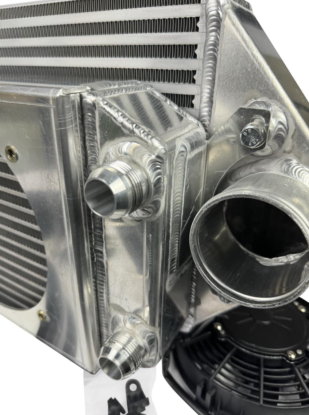 JackSpania Racing backdoor front mount intercooler with dual 3-inch pipes and full-size radiator, exterior view.