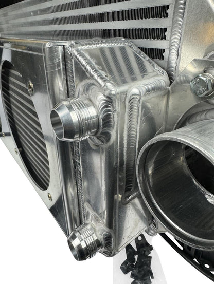 JackSpania Racing backdoor front mount intercooler with dual 3-inch pipes and full-size radiator combo, exterior view.