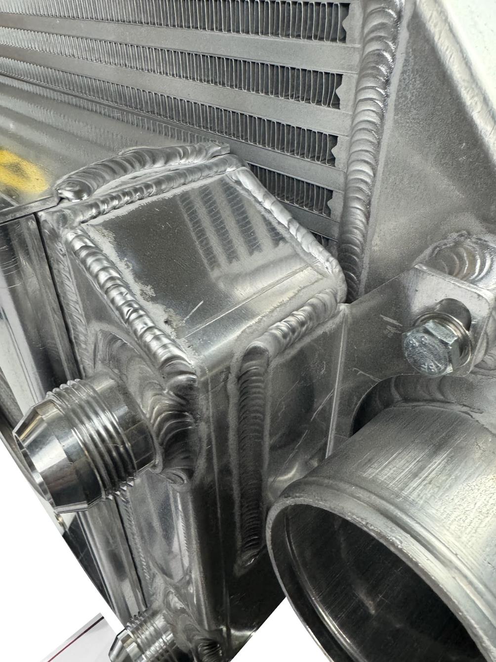 JackSpania Racing backdoor front mount intercooler with dual 3-inch tucked full-size radiator and 16AN fittings.