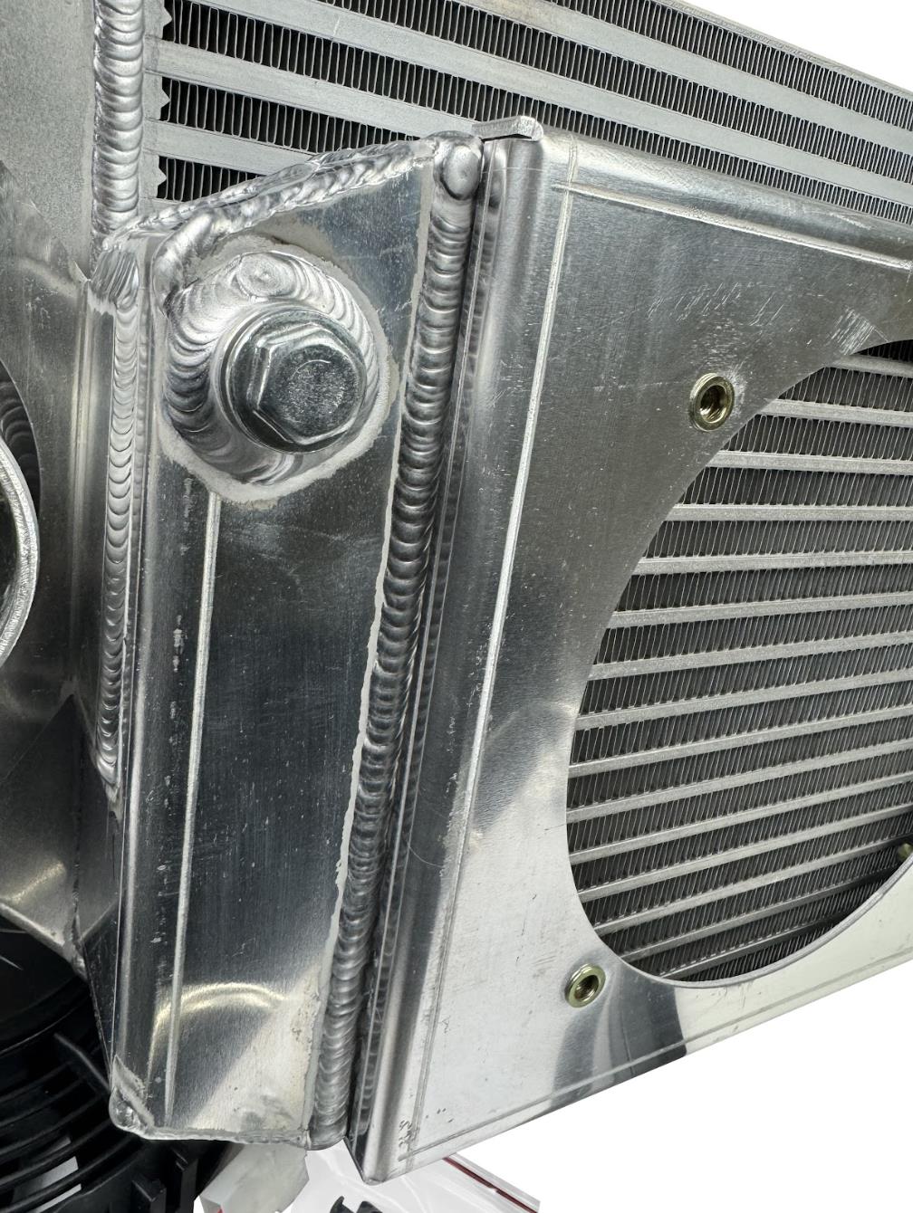 JackSpania Racing front mount intercooler and full-size radiator combo with dual 3-inch ducts and 16AN fittings, exterior view.