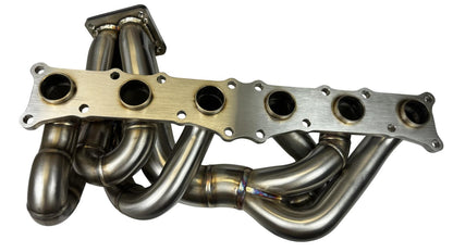 JackSpania Racing N54 top mount single front facing turbo manifold for 135i, 335i, 535i, and Z4, with T3 T4 divided exhaust design.