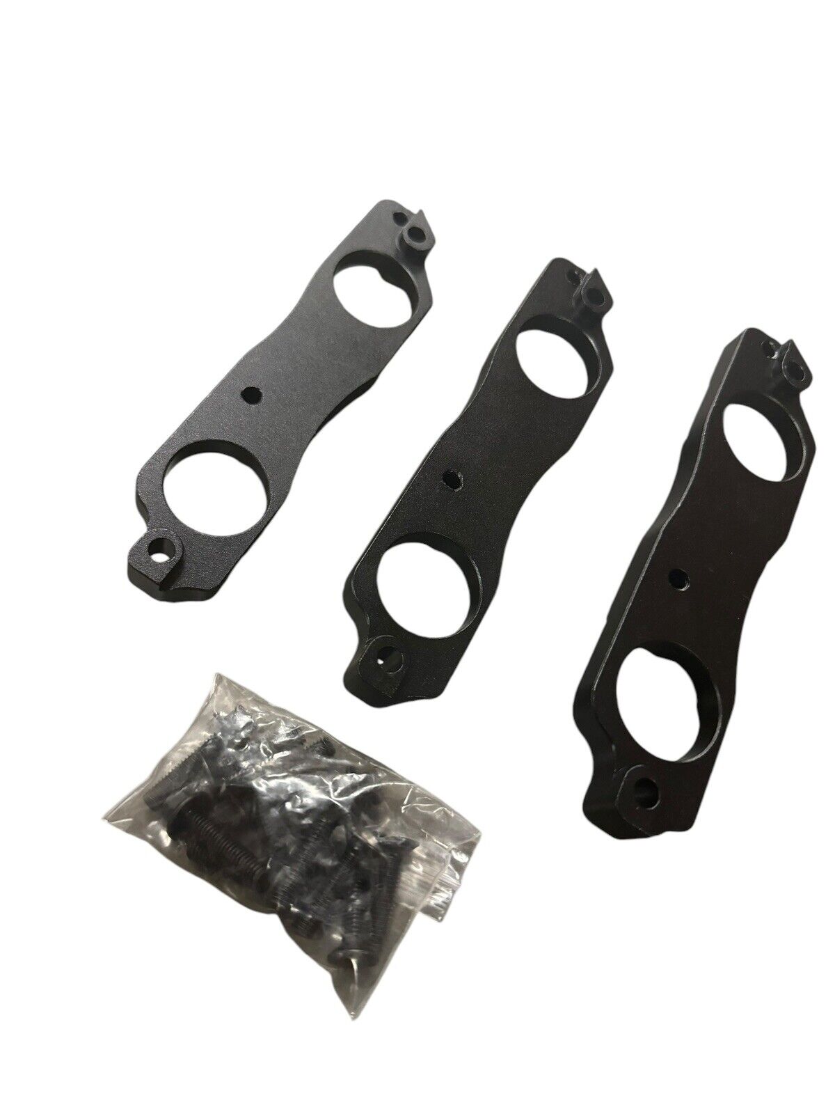 Black aluminum coil pack brackets for R35 GTR, compatible with Toyota 1JZ and 2JZ engines, by JackSpania Racing.