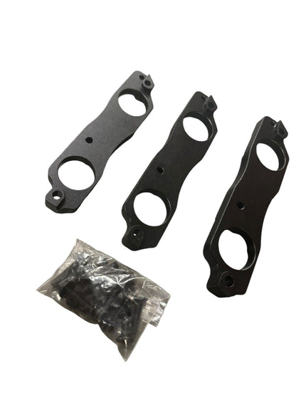Black aluminum coil pack brackets for R35 GTR, compatible with Toyota 1JZ and 2JZ engines, by JackSpania Racing.