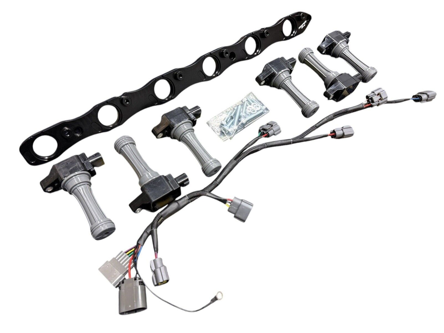 VR38 twin cam ignition coil conversion kit for Nissan RB R32 GTR engine, featuring JackSpania Racing branded engine parts.