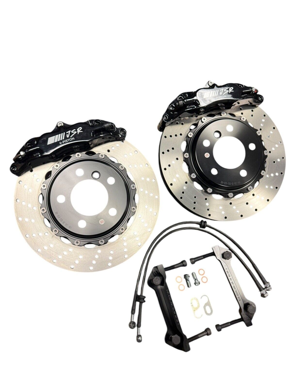JackSpania Racing Big Brake Kit with drilled rotors and 4-piston calipers for BMW E46 2001-2006, shown in an interior setting
