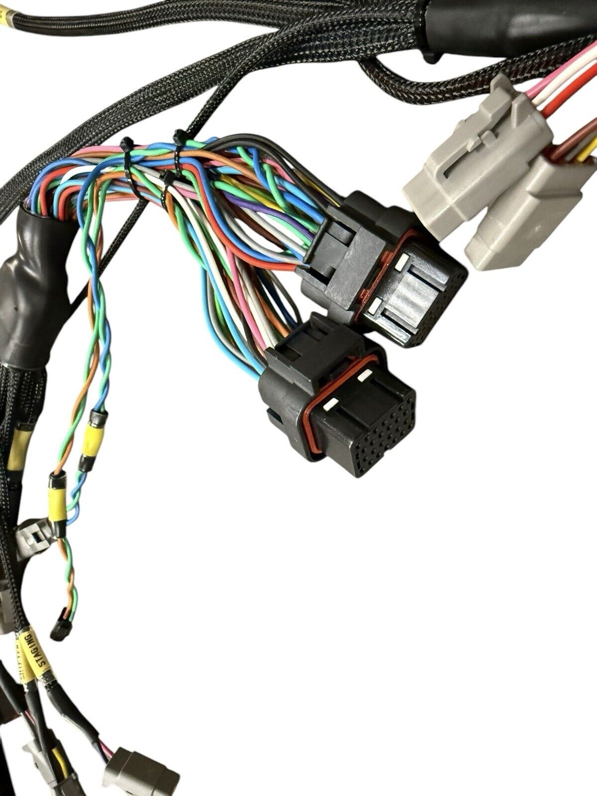 Engine wiring harness for Fueltech FT550, 2JZ VVTi, and EV1, by JackSpania Racing, with multiple connectors and wiring for engine installation.