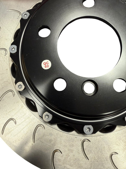 Big brake kit with drilled rotors and 4-piston calipers for BMW E46, by JackSpania Racing, interior view showing brake components.
