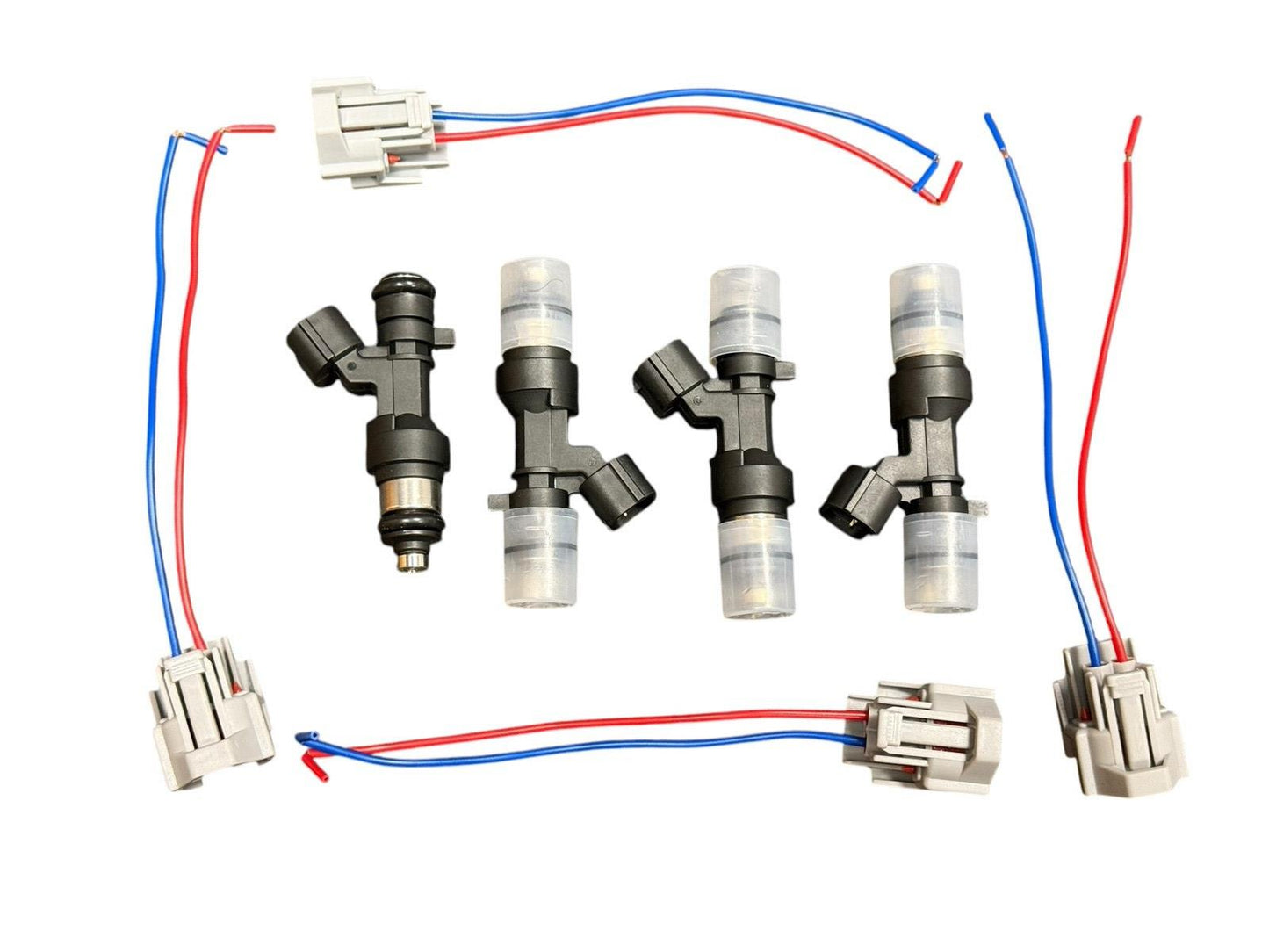 Set of four JackSpania Racing K Series 1200cc fuel injectors for Honda and Acura engine performance upgrades.