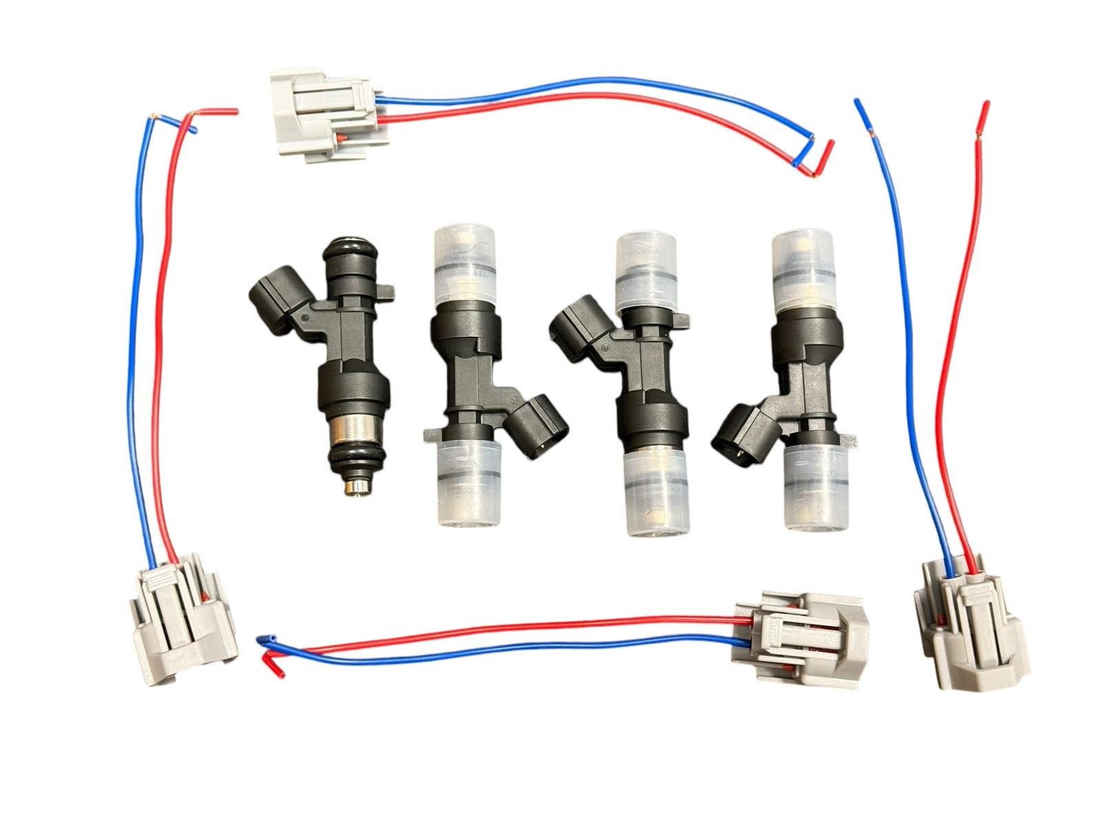 Set of four JackSpania Racing K Series 1200cc fuel injectors for Honda and Acura engine performance upgrades.
