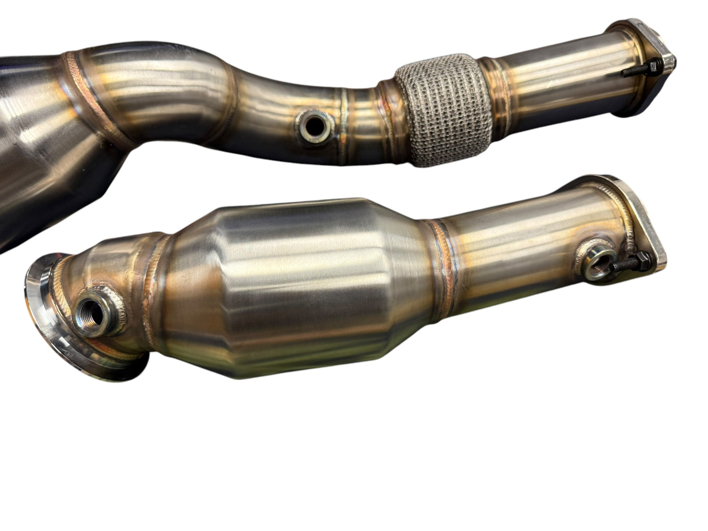 JackSpania Racing BMW S58 M2 G80 M3 G82 M4 G87 M2 high flow downpipes with cats, showcasing their polished exhaust components.