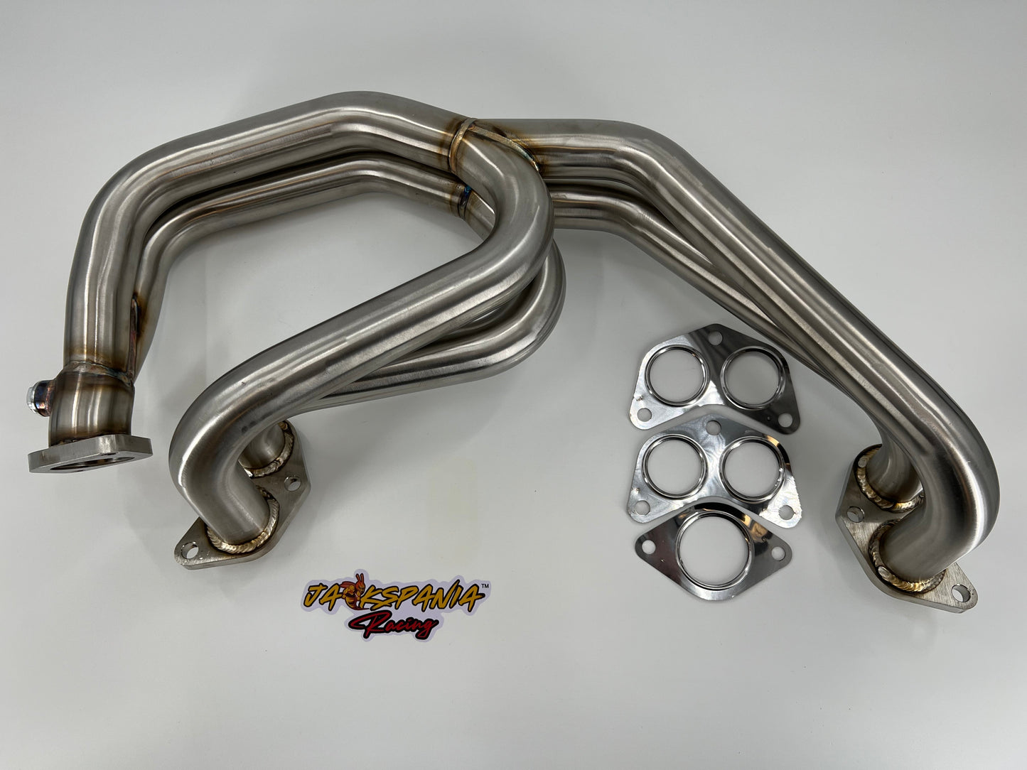 Subaru WRX and STi EJ25 equal length exhaust manifold header by JackSpania Racing, showcasing polished metal construction and inlet ports.