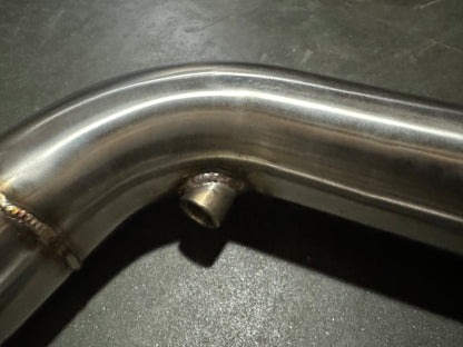 Stainless steel 3-inch downpipe for BMW S55 M3 M4 F80 F82 F87, exhaust part by JackSpania Racing, showing shiny pipe with mounting points.