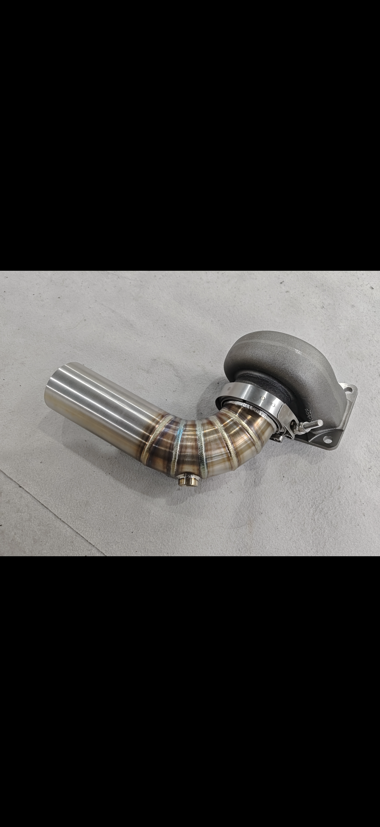 JackSpania Racing 3-inch downpipe with V-band flange and O2 bung, designed for Garrett Holset and BorgWarner turbo exhaust systems.