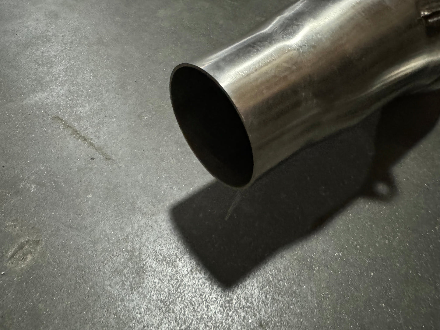 3-inch stainless steel downpipe for BMW S55 F80 F82 F87 M3 M4 F80 F82 F83 from JackSpania Racing, showing the exhaust pipe with flanges.