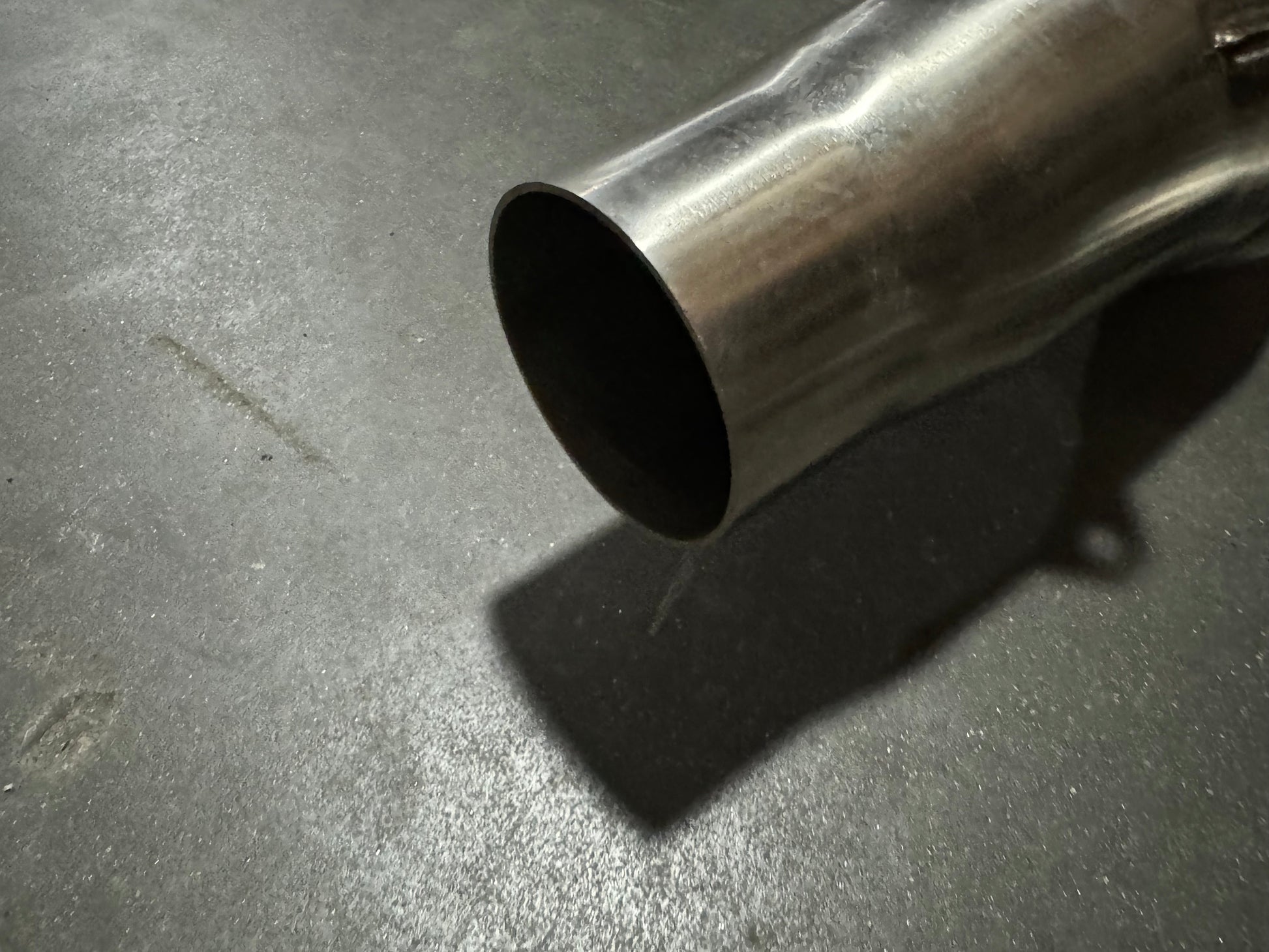 3-inch stainless steel downpipe for BMW S55 F80 F82 F87 M3 M4 F80 F82 F83 from JackSpania Racing, showing the exhaust pipe with flanges.