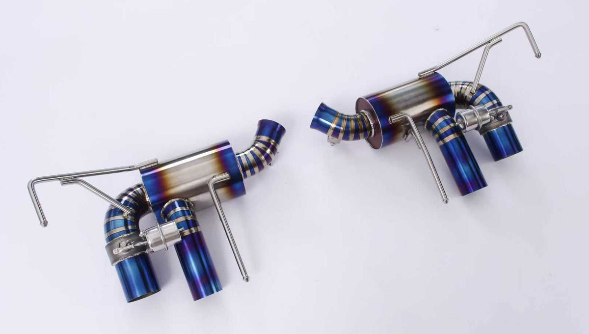 JackSpania Racing Ferrari California 4.3 V8 titanium valved exhaust system close-up showing polished metal pipes and exhaust tips.