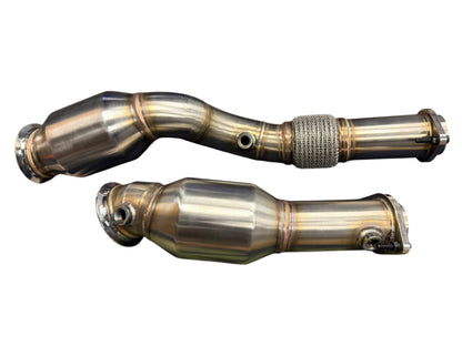High flow downpipes with cats for BMW S58 M2 G80 M3 G82 M4 G87 by JackSpania Racing, showing polished exhaust components.