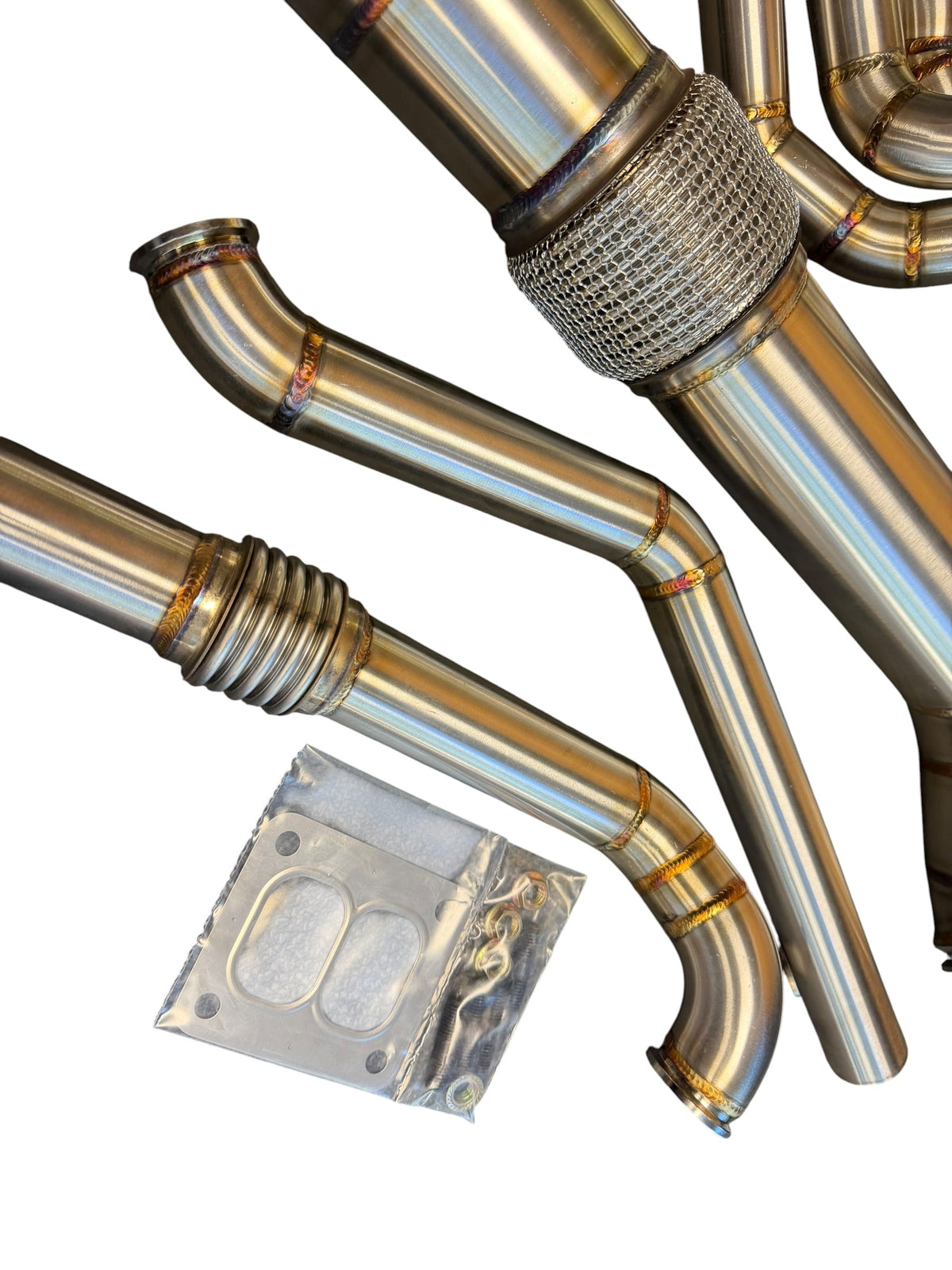 JackSpania Racing B58 Gen 2 6-port turbo hot-side kit for BMW M240i, M340i, M440i, and Toyota GR Supra A90/A91, with visible piping.