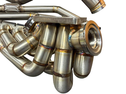 BMW S58 G80 G82 G83 G87 single turbo manifold hot-side kit by JackSpania Racing, showing the metallic turbo manifold components.