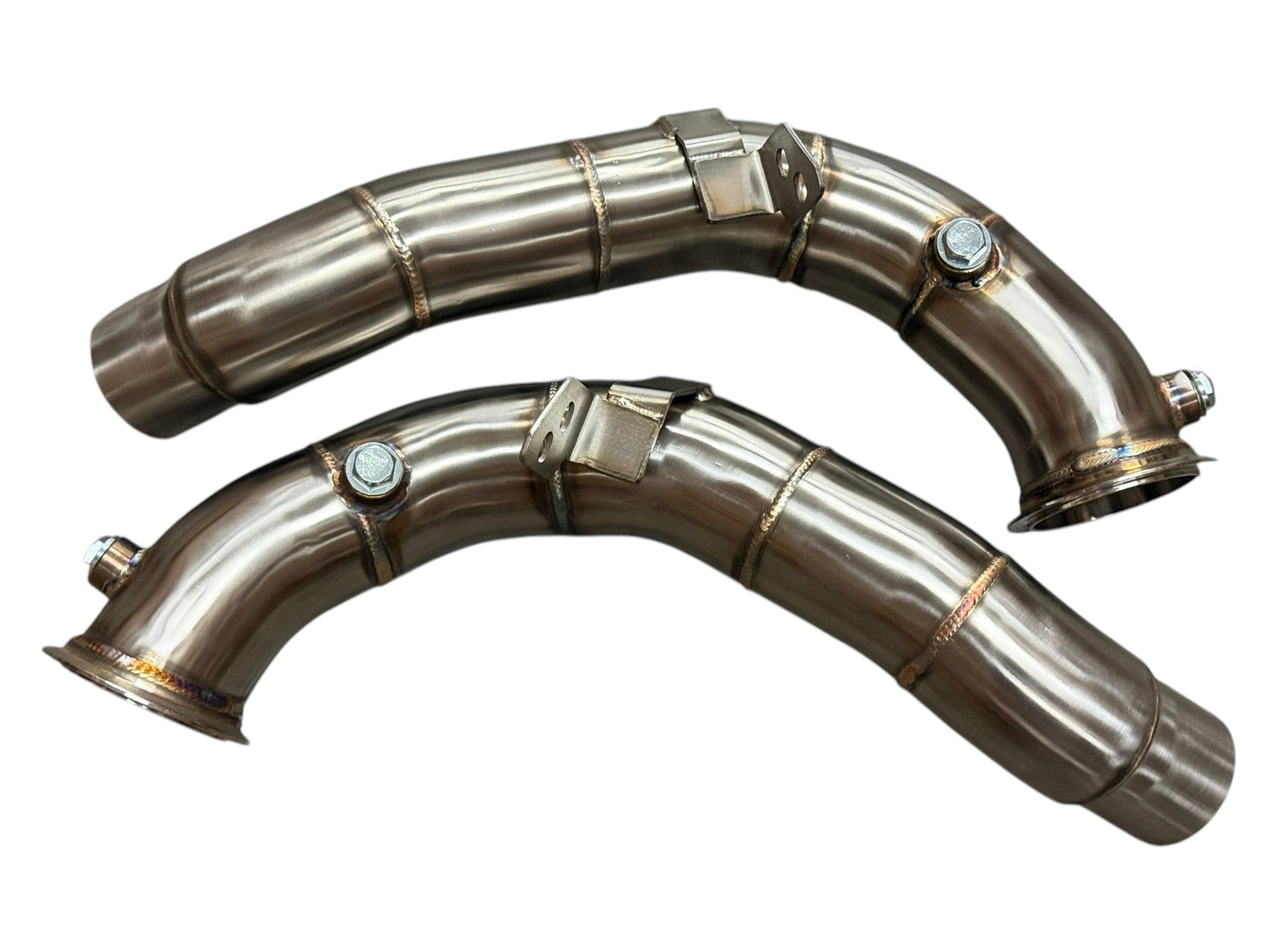 JackSpania Racing racing downpipes for BMW M5 and M6 S63 2011-2018, showing polished stainless steel exhaust pipes with mounting brackets.