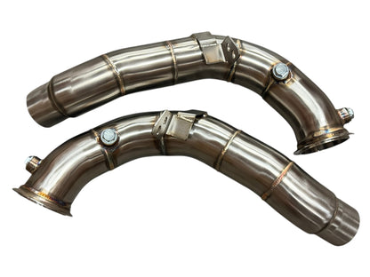 JackSpania Racing racing downpipes for BMW M5 and M6 S63 2011-2018, showing polished stainless steel exhaust pipes with mounting brackets.
