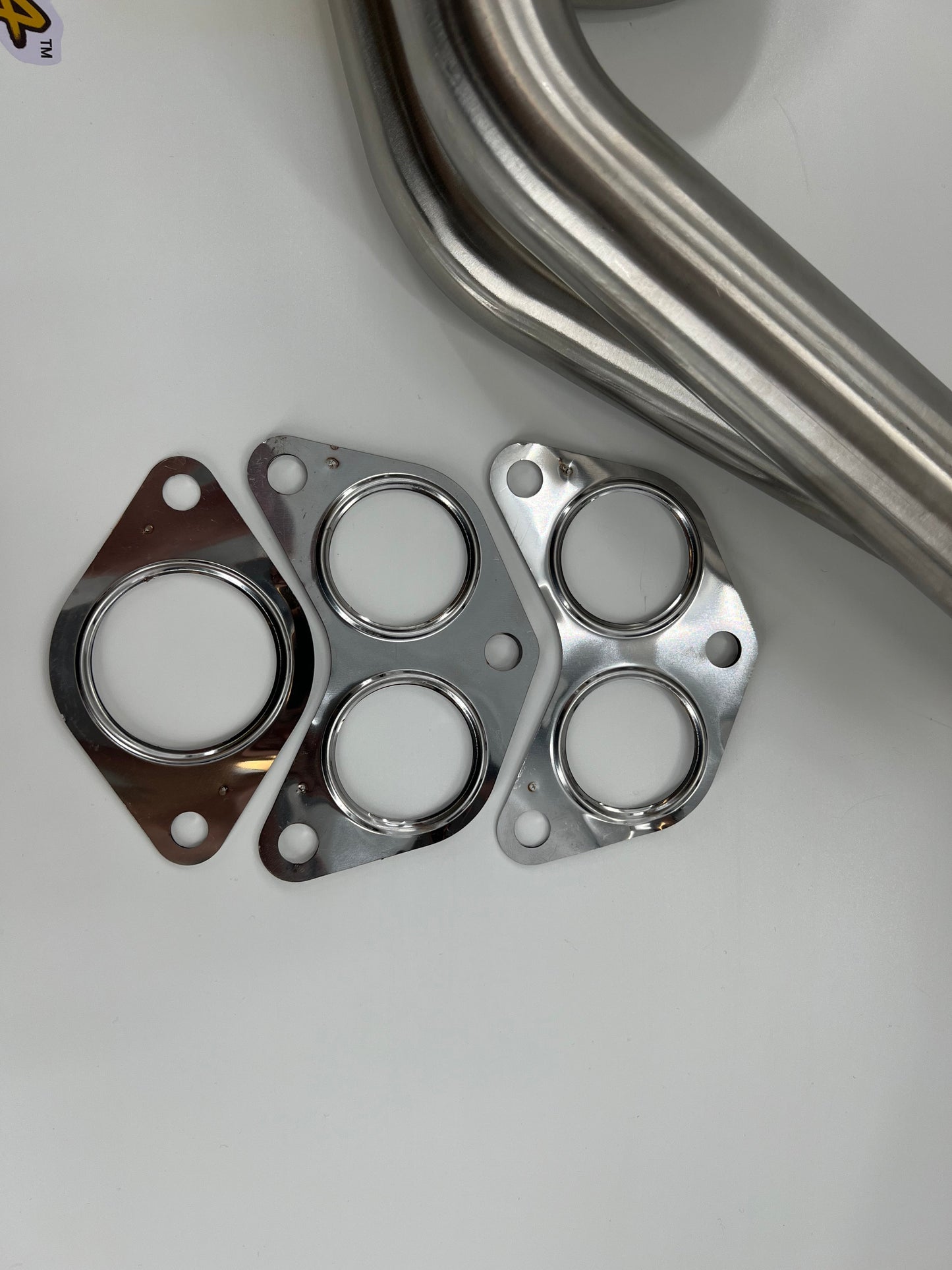 Subaru WRX and STi EJ25 equal length exhaust manifold header by JackSpania Racing, showing polished metal construction.