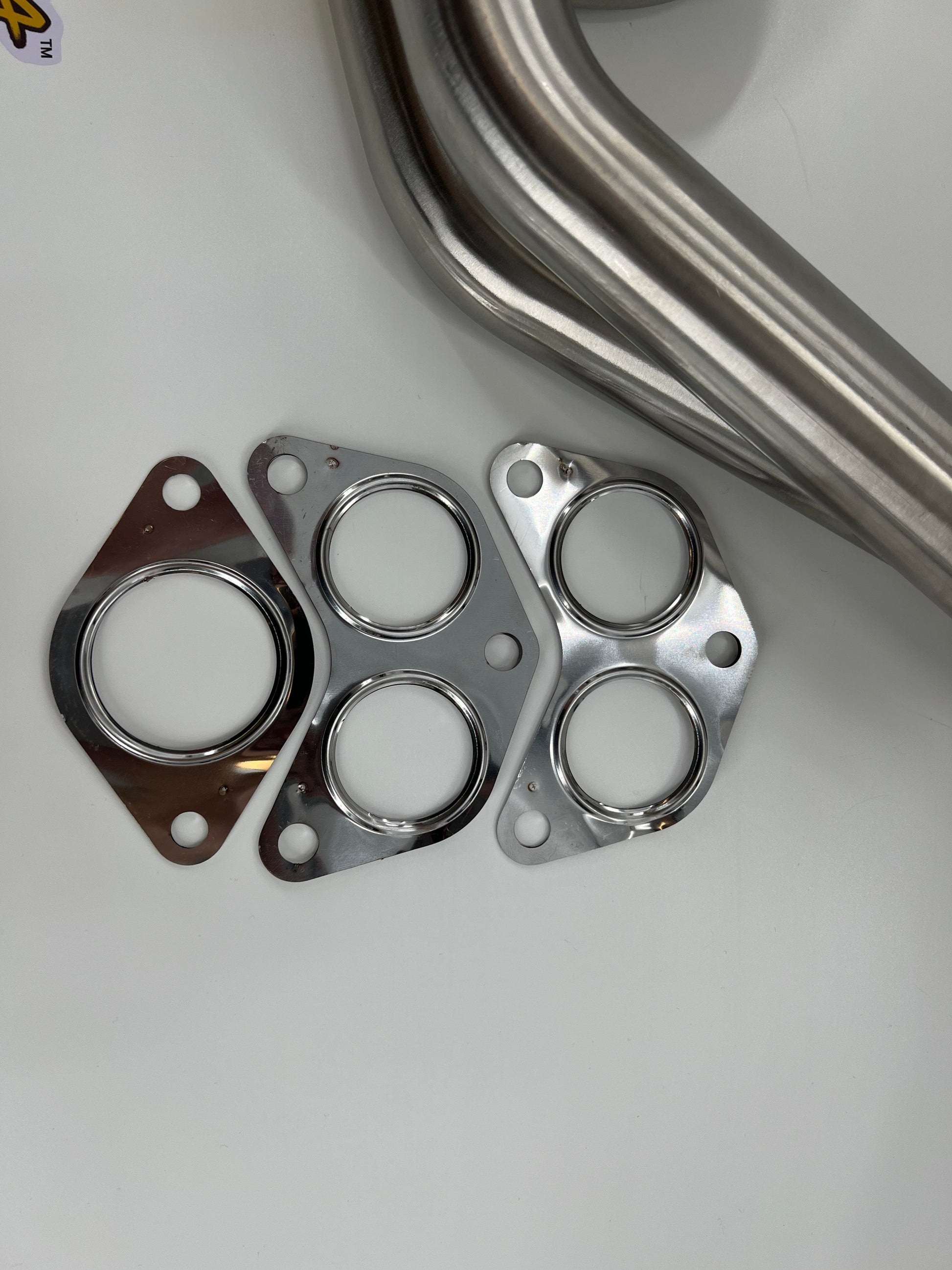 Subaru WRX and STi EJ25 equal length exhaust manifold header by JackSpania Racing, showing polished metal construction.