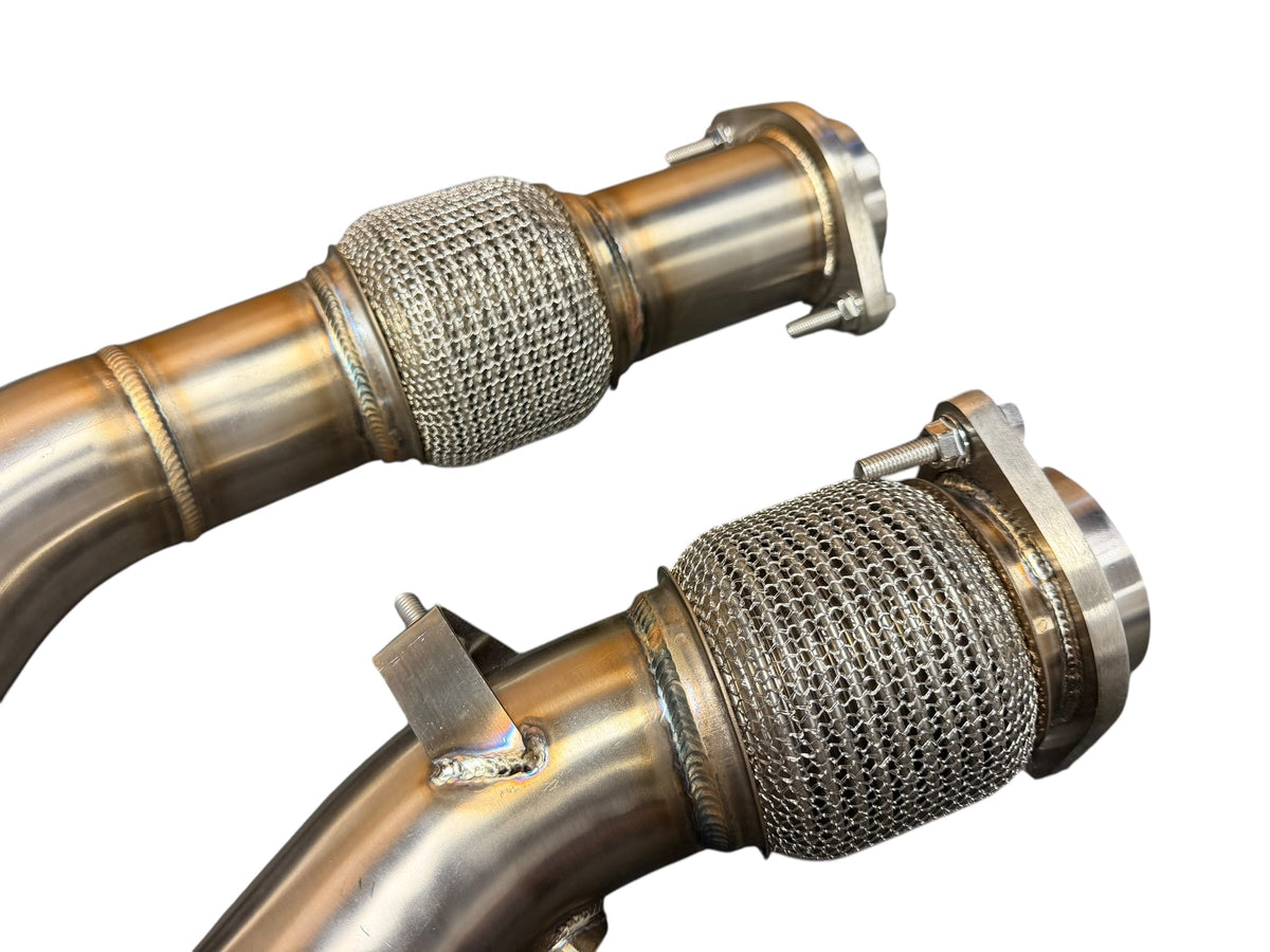 Downpipe for 2019+ BMW F97 X3M and F98 X4M with S58 3.0T engine, from JackSpania Racing, showing the exhaust pipe with mounting flanges.