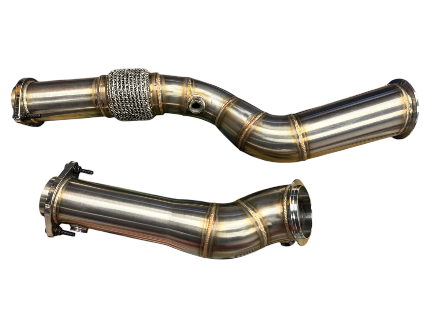 High flow non-catted BMW S58 M2 G80 M3 G82 M4 G87 M2 downpipes by JackSpania Racing, showcasing shiny stainless steel exhaust parts.