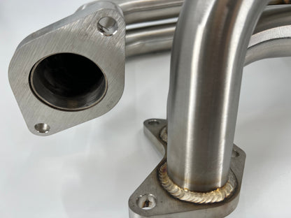 JackSpania Racing Subaru WRX STI EJ25 equal length exhaust manifold header showing polished metal pipes and mounting flanges.