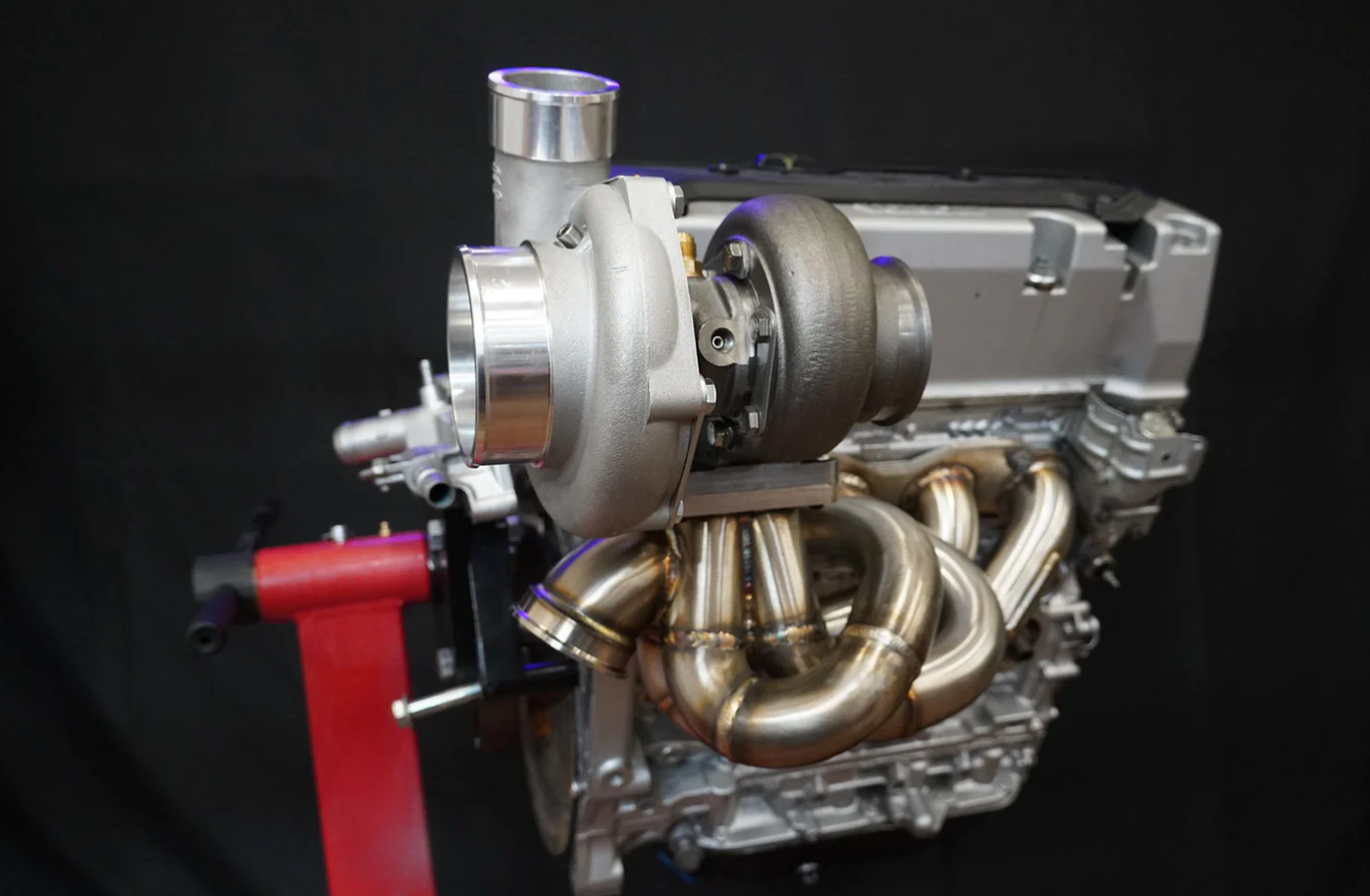 JackSpania Racing K20 K24 top mount T3 T4 60mm wastegate turbo manifold for K series K swap, suitable for AWD and FWD setups.