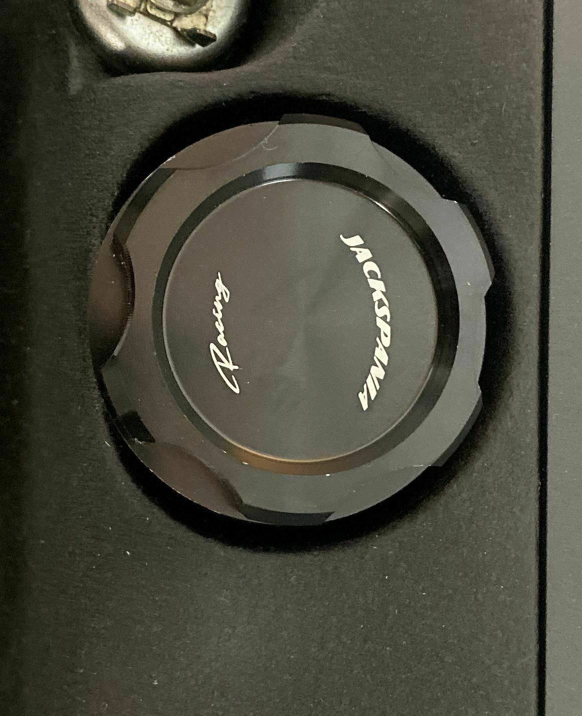 Jack Spania Racing BDFHJ Series valve cover oil cap for engine parts, featuring a sleek metal finish and detailed branding.