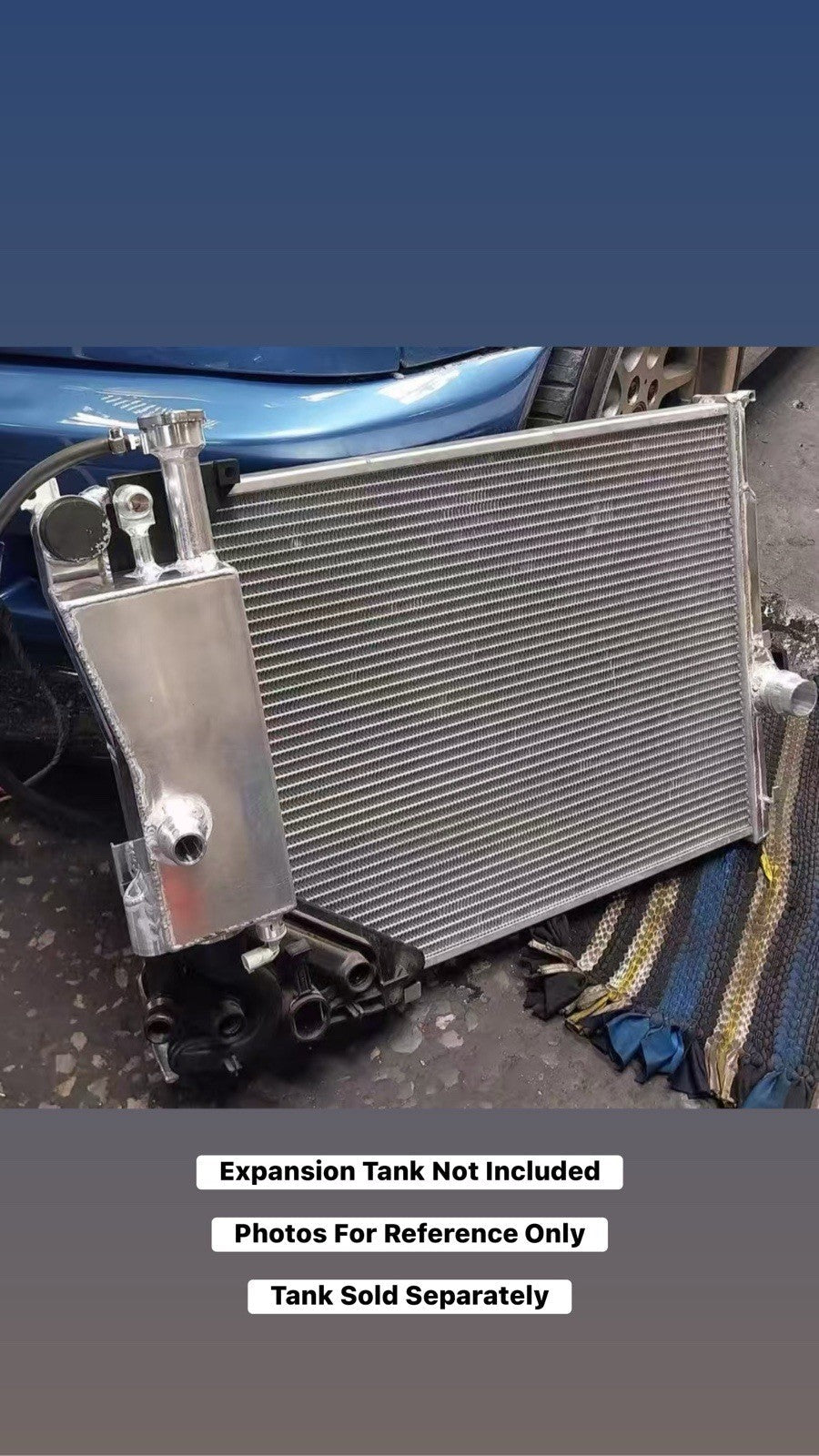 High performance JackSpania Racing heat exchanger radiator for BMW E46 3 Series M4 Z4 with engine parts, showing the radiator's core and fittings.