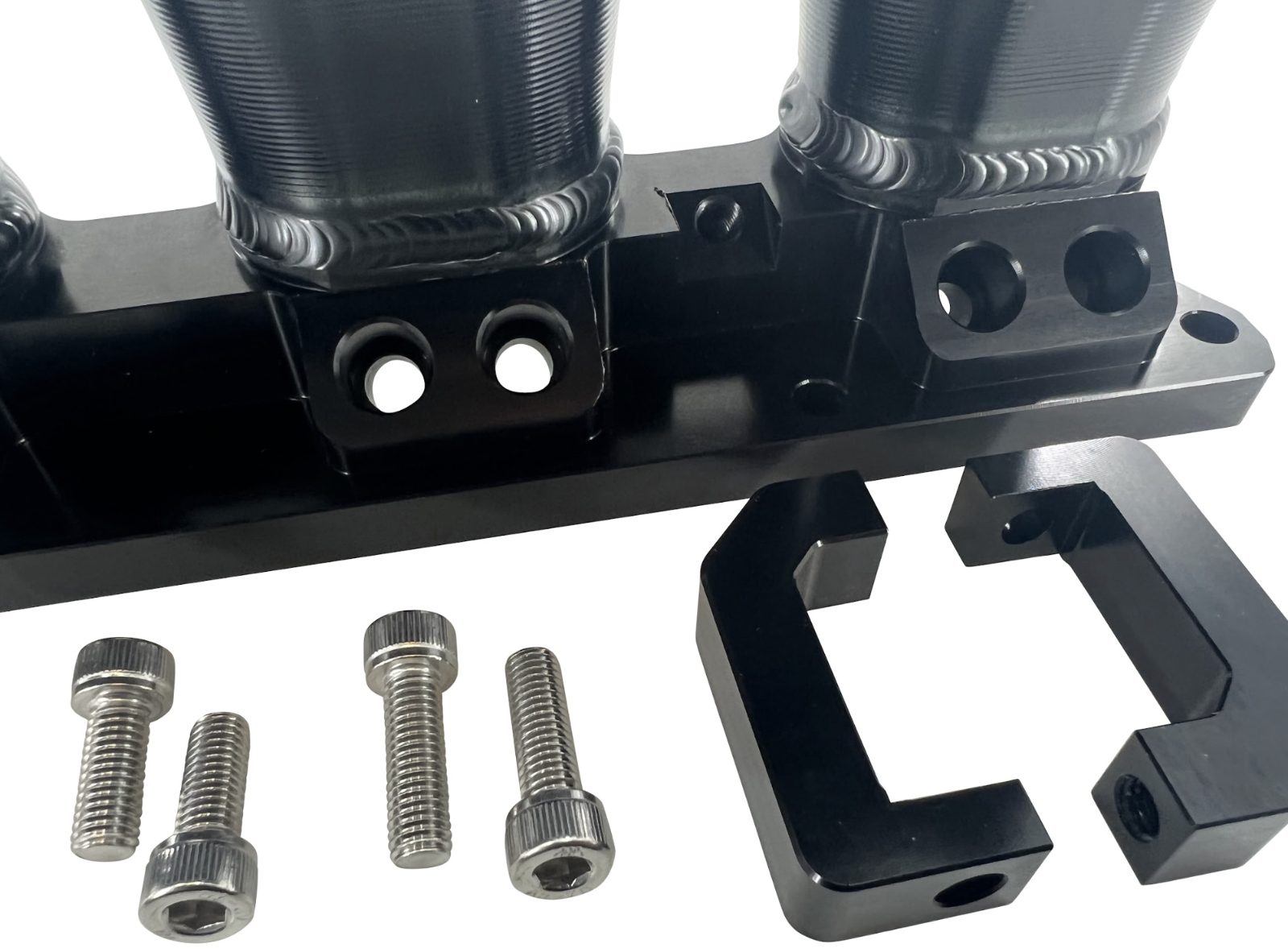 Jack Spania Racing billet K Series intake manifold adapter for Skunk2 Ultra engine parts, shown in close-up view.