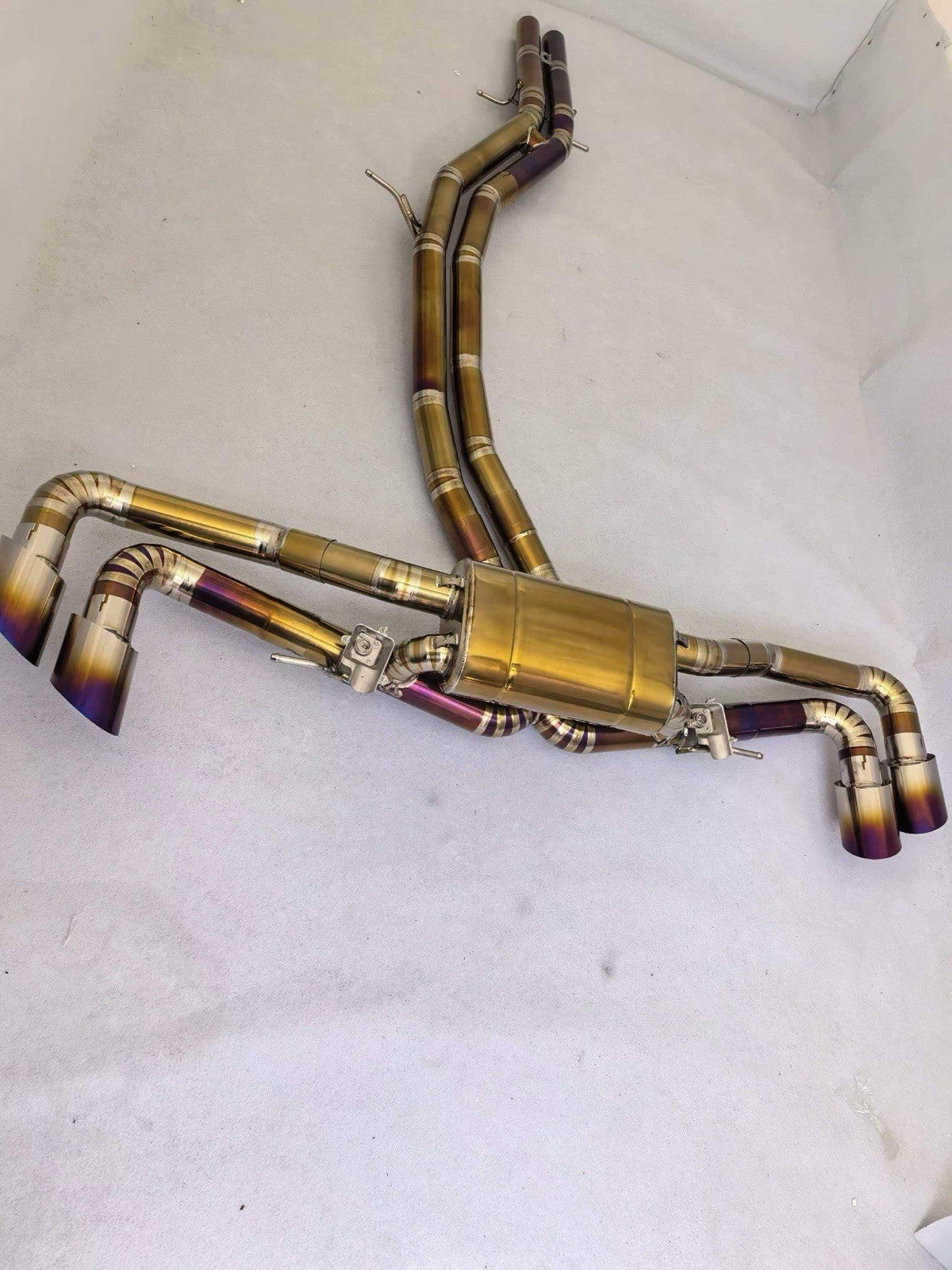 JackSpania Racing 3-inch titanium sport catback exhaust for Lamborghini Urus 2018-2024, showing the polished exhaust pipes and valves.